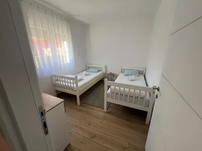 a small room with two beds and a window at Apartman Milos - centar grada free parking in Vranje