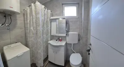 a small bathroom with a toilet and a sink at Apartman Milos - centar grada free parking in Vranje