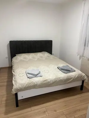a bed with two towels on it in a room at Apartman Milos - centar grada free parking in Vranje