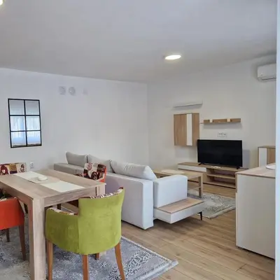 a living room with a couch and a table at Apartman Milos - centar grada free parking in Vranje