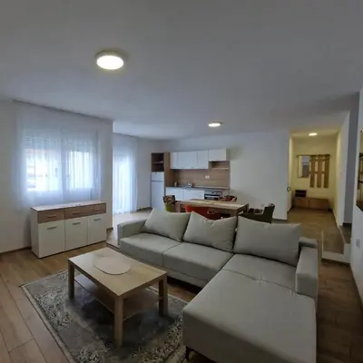 a living room with a couch and a table at Apartman Milos - centar grada free parking in Vranje