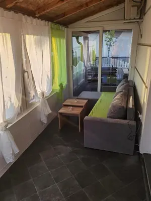 a living room with a couch and a table at Apartman VRH in Vrnjačka Banja
