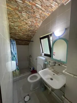 a bathroom with a white toilet and a sink at Marko Konak in Niš