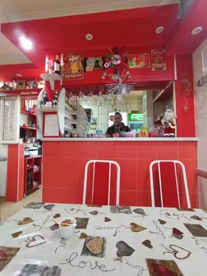 a man in the kitchen of a restaurant with a table at Marko Konak in Niš