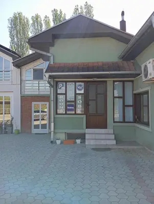 a small building with a door on a street at Marko Konak in Niš