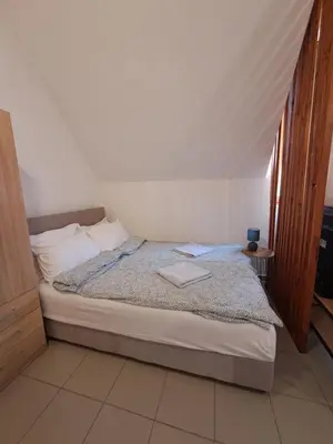 a bedroom with a bed with a laptop on it at Sofi III in Niš
