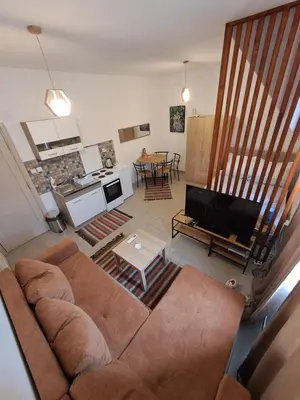 a living room with a couch and a tv at Sofi III in Niš
