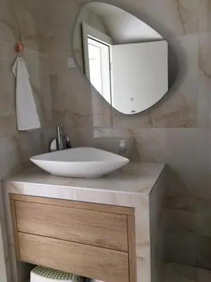 a bathroom with a sink and a mirror at Apartman TERASA in Beljevina