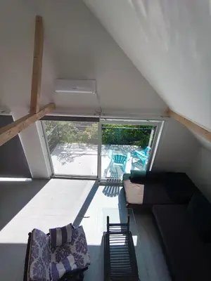 a living room with a couch and a window at Apartman TERASA in Beljevina