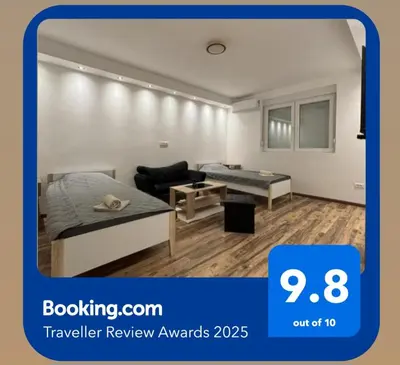 a living room with a bed and a couch at Apartman Centar in Kuršumlija
