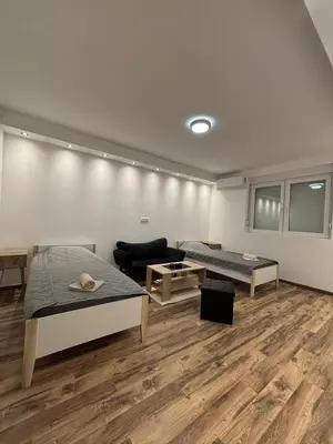 a room with two beds and a couch at Apartman Centar in Kuršumlija