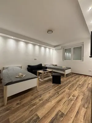a living room with two beds and a couch at Apartman Centar in Kuršumlija
