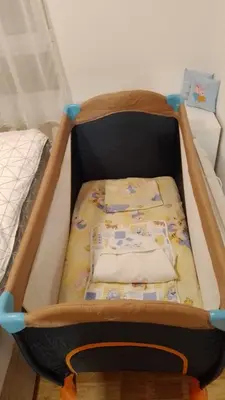 a crib with a blanket in a bedroom at Apartman Sky view - Sokobanja in Soko Banja