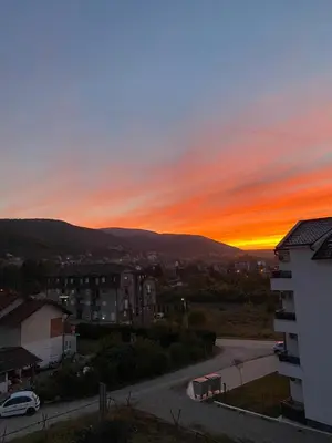 a sunset from the balcony of a building at Apartman Sky view - Sokobanja in Soko Banja