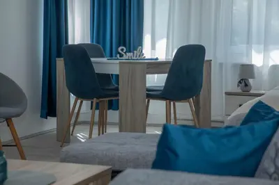 a living room with a table and two chairs at Apartmani Rosica in Ribarska Banja