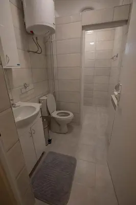 a small bathroom with a toilet and a sink at Apartmani Rosica in Ribarska Banja