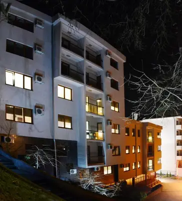 a tall building at night with its lights on at Apartments Villa Splendor in Vrnjačka Banja