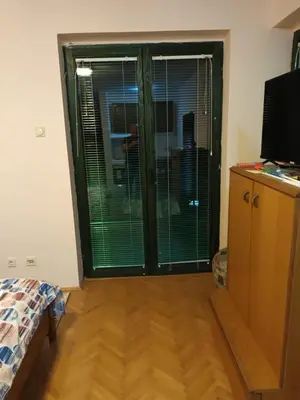 a room with a large window with blinds on it at Apartmani Jelena in Vrnjačka Banja