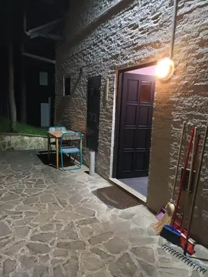 a brick building with a door and a table at Apartmani Jelena in Vrnjačka Banja