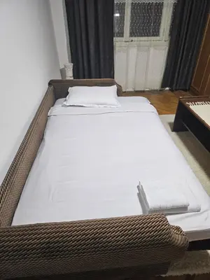 a bed in a room with a white mattress at Apartman NINA in Kuršumlija