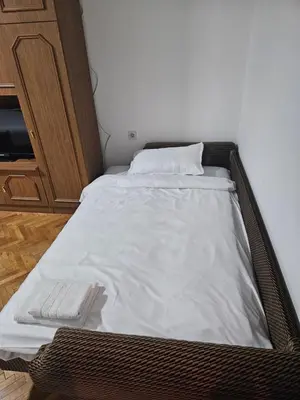 a bed in a room with a white mattress at Apartman NINA in Kuršumlija