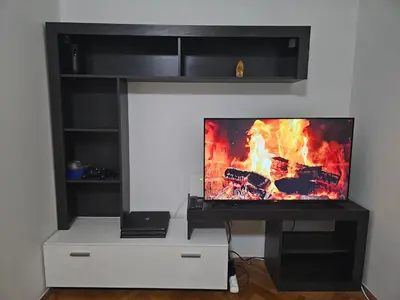 a flat screen tv sitting on top of a tv stand at Apartman NINA in Kuršumlija