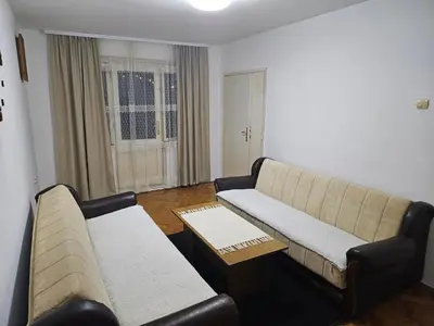a living room with a couch and a table at Apartman NINA in Kuršumlija