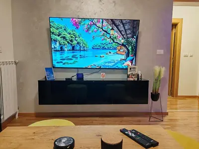 a large flat screen tv sitting on top of a table at Apartman ARMANE 4 star LUX & Free EVcharge in Vrnjačka Banja