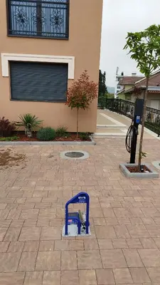 a blue object is sitting on a brick patio at Apartman ARMANE 4 star LUX & Free EVcharge in Vrnjačka Banja