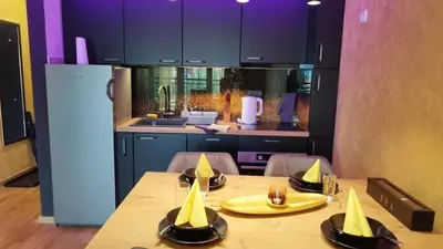 a kitchen with a table with bananas on it at Apartman ARMANE 4 star LUX & Free EVcharge in Vrnjačka Banja