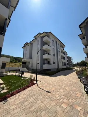 a large apartment building with a brick patio at Tina Apartman Sokobanja in Soko Banja