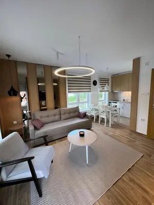 a living room with a couch and a table at Verde Apartman Sokobanja in Soko Banja