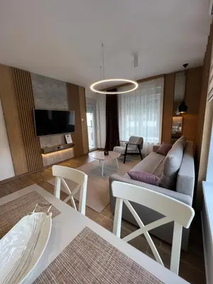 a living room with a couch and a table at Verde Apartman Sokobanja in Soko Banja