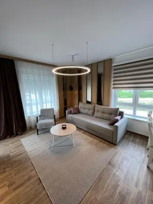 a living room with a couch and a table at Verde Apartman Sokobanja in Soko Banja
