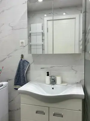 a white bathroom with a sink and a mirror at Sunset in Niš