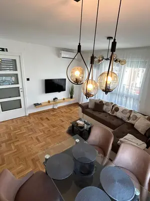 a living room with a couch and a table at Sunset in Niš