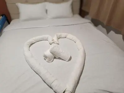 a heart made out of a stuffed elephant on a bed at PREMIUM APARTMAN ELENI ROOMS,oaza mira i tisine u centru Vrnjacke banje in Vrnjačka Banja