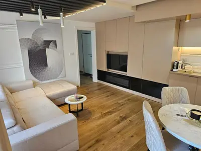 a living room with a couch and a table at PREMIUM APARTMAN ELENI ROOMS,oaza mira i tisine u centru Vrnjacke banje in Vrnjačka Banja