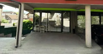 a covered porch of a house with a car at Simone in Pojate