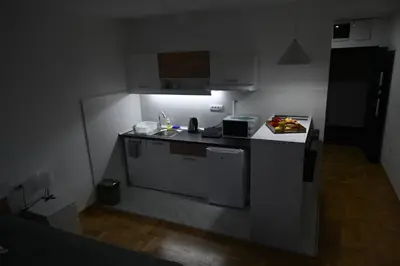 a small kitchen with a sink and a stove at Riverside Nis in Niš