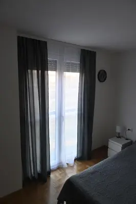 a bedroom with a bed and a large window at Riverside Nis in Niš