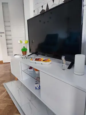 a white entertainment center with a large flat screen tv at Apartman PINA Vrnjacka Banja in Vrnjačka Banja