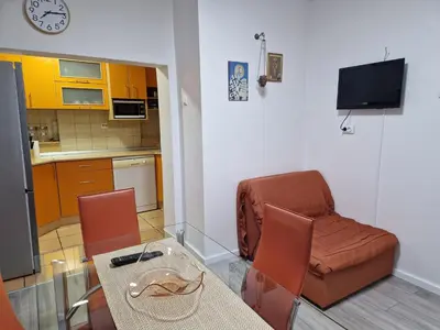 a living room with a glass table and a chair at Apartment F.R.I.E.N.D.S in Paraćin
