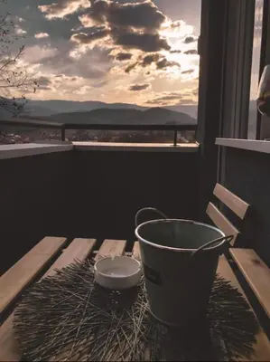 a bucket on a table on a balcony with a view at BlueSky in Vrnjačka Banja