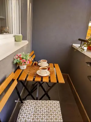 a wooden table with cups and saucers on it at BlueSky in Vrnjačka Banja