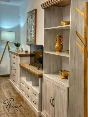 a living room with a tv and a wooden cabinet at Princ house in Leskovac