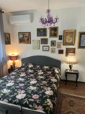 a bedroom with a bed with a floral comforter at Vrnjacka Renesansa Promenada in Vrnjačka Banja