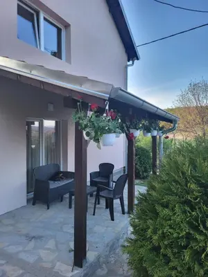 a pergola with a table and chairs on a patio at Apartment Pavlović in Soko Banja
