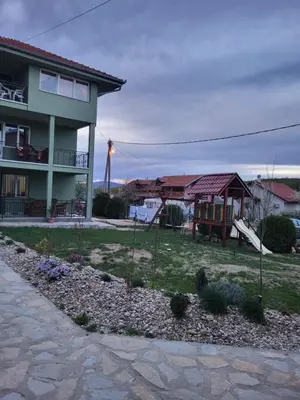 a house with a yard with a playground at Apartment Pavlović in Soko Banja