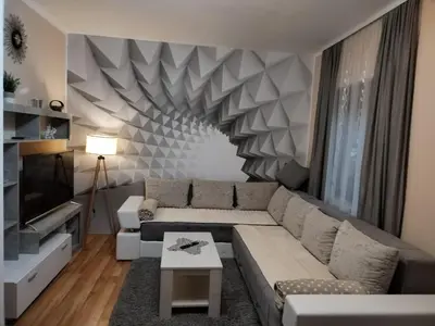 a living room with a couch and a television at Apartman Tina in Soko Banja